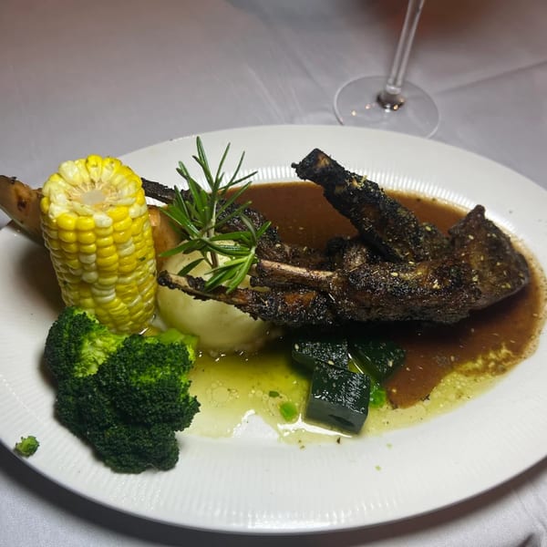 La Brochette Bistro's lamb chops with mashed potatoes, corn, broccoli, and zucchini in sauce.