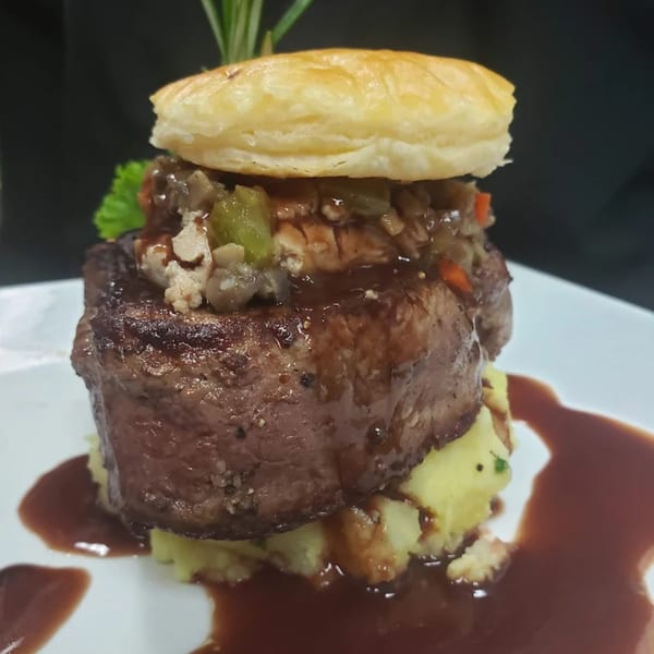 La Brochette Bistro's filet mignon with mashed potatoes, gravy, and a puff pastry topping.