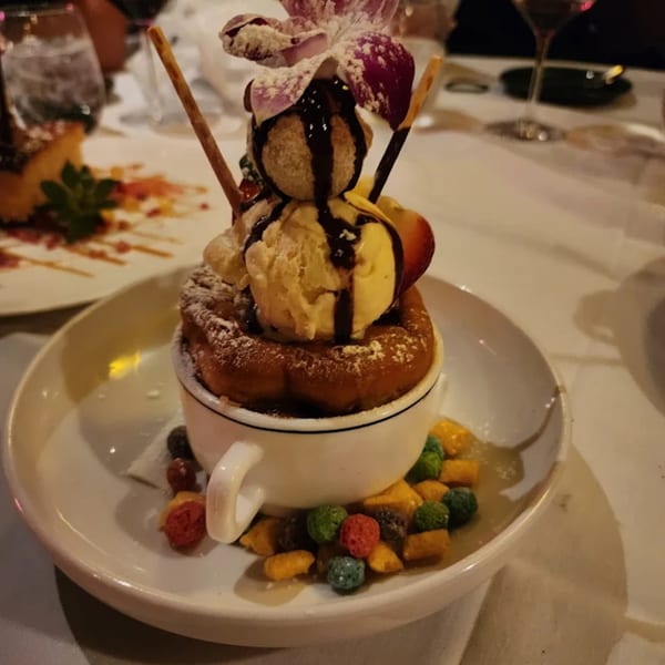 La Brochette Bistro's dessert: a souffle with ice cream, chocolate drizzle, and an orchid garnish.