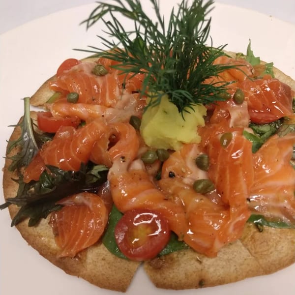 La Brochette Bistro's salmon tartine with capers, cherry tomatoes, dill, and a dollop of wasabi.
